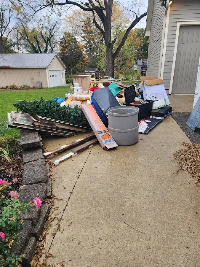 Dumpster being loaded with debris for 12 Yard Dumpster Rental in Ashford